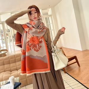 Elegant floral and mountain print cashmere-like scarf with fringe on female model