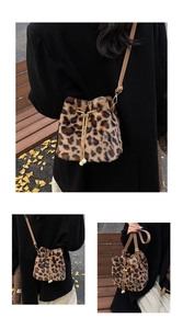 Detail of leopard print plush bucket bag featuring gold drawstring chain and pearl pendant