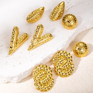 Elegant gold titanium steel earring set with geometric textures on white stone base