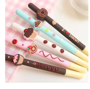 Macro detail of silicone dessert pens featuring 3D donuts and cakes on a pink grid