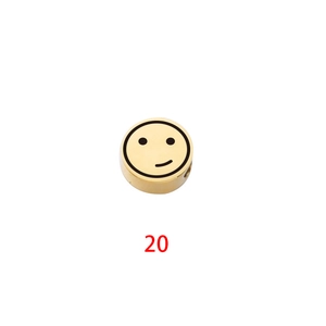 Detailed view of round gold stainless steel bead with smiley face engraving for jewelry DIY