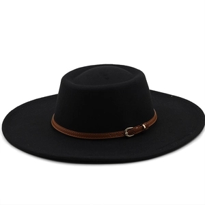 Detail of the brown leather belt and metallic buckle on the black wool felt wide brim hat