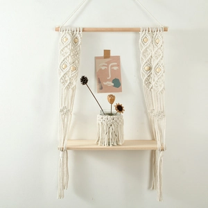Handmade boho macrame wall hanging shelf with wood beads and off-white cotton rope