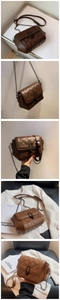 Detail of a brown quilted leather crossbody bag with chain strap and black twist lock