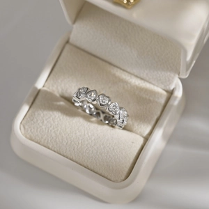 Close-up of heart-shaped cubic zirconia wedding ring set in a velvet jewelry box