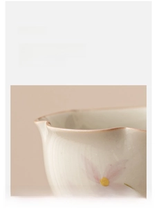 Detailed close-up of ceramic tea cup showing smooth glaze and pink floral pattern