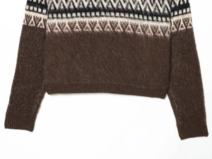 Detail of Nordic retro knit sweater hem with Fair Isle geometric jacquard patterns
