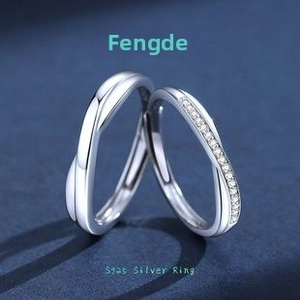 Close-up of S925 sterling silver Mobius twist rings for couples with pavé zircon stones