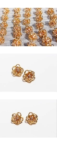Macro detail of sky blue flower earrings with gold plating and cubic zirconia petals