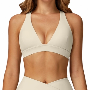 Creamy white deep V-neck sports bra with wide straps and high-waist crisscross leggings
