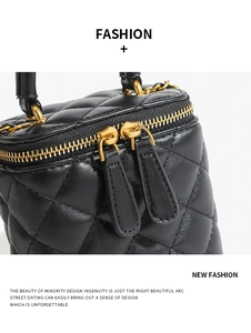 Detailed close-up of a quilted leather mini vanity bag with gold-tone hardware and chain