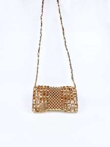 Detail of gold woven bead handbag with intricate mesh texture and metal chain strap