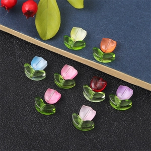Colorful tulip glass beads for DIY jewelry making laid on dark textured surface