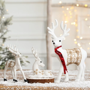 Three-piece set of white flocked Christmas reindeer ornaments with gold and red accents