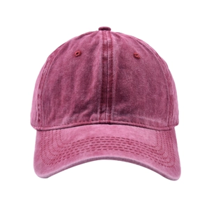 Detail of vintage washed burgundy cotton baseball cap showing distressed texture