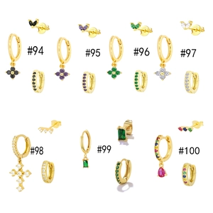 Macro detail of gold-plated earring sets with colorful zirconia and S925 silver hallmarks