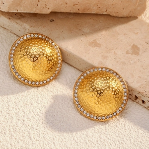 Detail view of 18K gold plated hammered dome earrings with sparkling zircon inlay