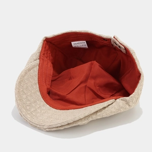 Béret de style britannique à texture gaufrée beige avec doublure rouge éclatant