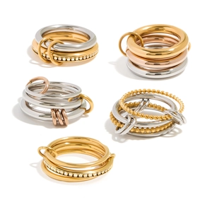 Multi-link 18K gold and silver rings set with cubic zirconia and twisted texture