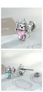 Detailed view of silver cat chef ear studs with heart-shaped pink and blue gemstones