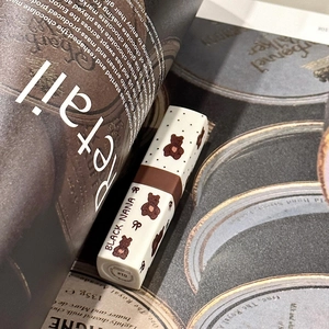 Close-up of matte bear lipstick tube 01 on a magazine with vintage aesthetic charm