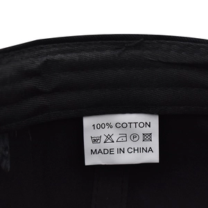 Detail shot of white care label showing 100% cotton material and made in China text