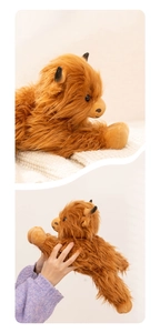 Detailed close-up of a fluffy ginger Highland cow plush toy showing its soft long fur texture