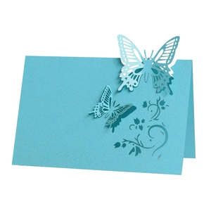 Sky blue laser-cut butterfly place card with floral hollow pattern for wedding table