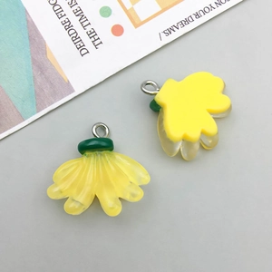Close-up of a realistic resin yellow banana pendant with a silver metal hanging loop