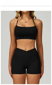 Detail of high-waist yoga shorts with crossover V-waistband and side phone pocket in black