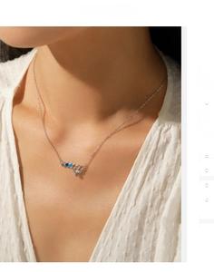 Detail view of s925 silver necklace with rainbow bee and honeycomb pendant on model
