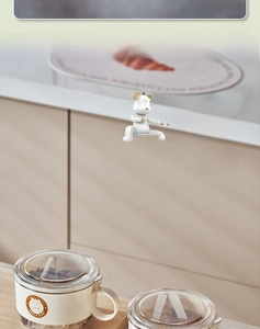 Detail of cream spice storage box with transparent lid and cute golden bear decoration