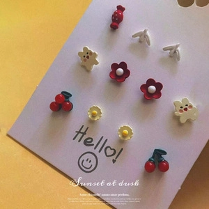 Macro shot of colorful cartoon resin earrings including candy and bear shapes on display
