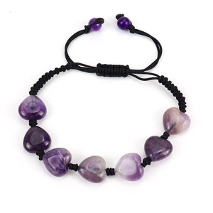 Detailed macro shot of hand-woven bracelet with heart-shaped purple agate and black cord