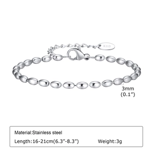 Close-up of silver stainless steel oval bead bracelet with engraved K18 charm tag