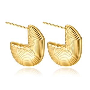 Detail showing gold C-shaped earrings with unique fingerprint texture on a white background