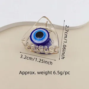 Detail view showing blue Evil Eye hair claw clip dimensions 3.2cm wide and 6.5g weight