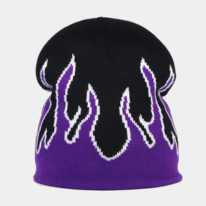 Detailed view of knitting texture and purple flame jacquard pattern on the beanie