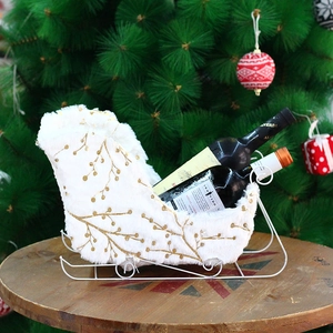 White velvet Christmas sleigh wine rack with gold branch texture for holiday table decor
