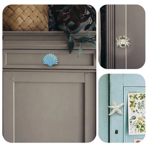 Detail of vintage ocean themed knobs in shell crab and starfish shapes for cabinet decor
