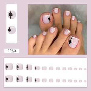 Lavender French tip press-on toenails with black hearts and sparkling rhinestones