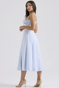 Detail of light blue floral dress showing slim fit, spaghetti straps and drawstring chest