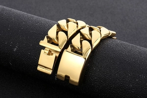 Macro shot of 20mm gold-plated titanium steel Cuban chain with sleek folding clasp details