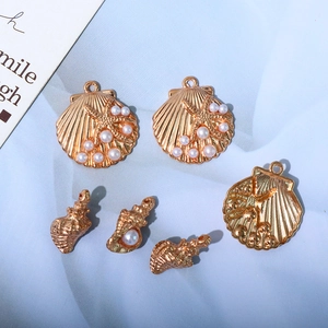 Golden shell and conch charms with white pearls for DIY ocean-themed jewelry making