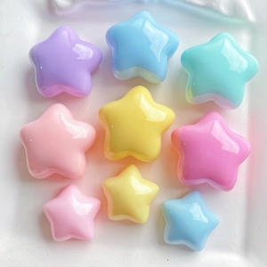 Close-up of colorful puffy star resin charms in various sizes for DIY crafting and phone cases