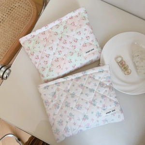 Detailed close-up of quilted floral cotton makeup bags with simple wish woven labels