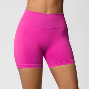 Detailed close-up of high-waist seamless compression fitness shorts in vibrant rose pink