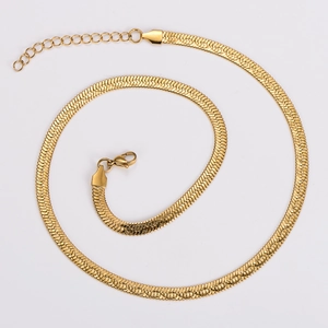 Detail of a golden snake chain necklace with lobster clasp and adjustable extension chain