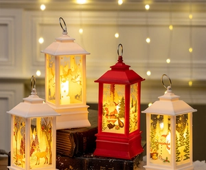 Close-up of vintage Christmas lanterns with Santa and elk patterns on rustic books
