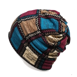 Close-up of retro checkered knit beanie with blue and red zigzag patterns
